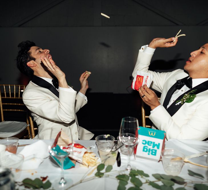 Groom and groom eating a McDonalds Big Mac meal