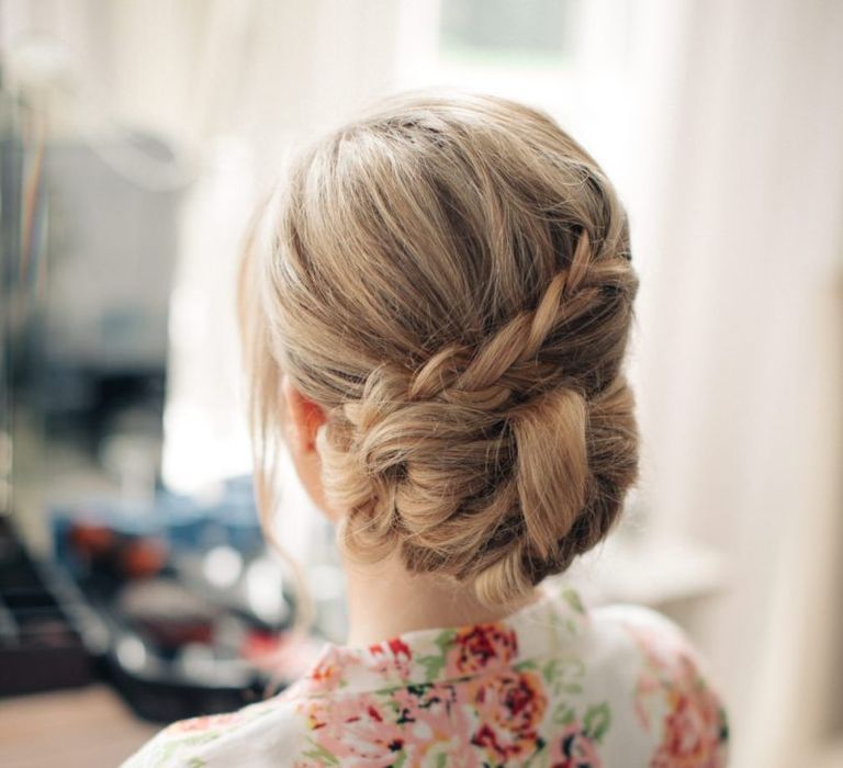 Elegant braided wedding hair pinned into a bun