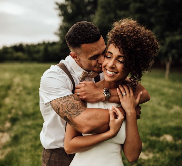 Black bride in Maggie Sottero wedding dress with short afro hair