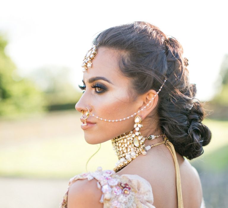 Asian bride with pinned hair and Indian accessories