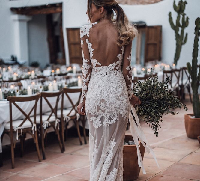 Bride in lace wedding dress with ponytail