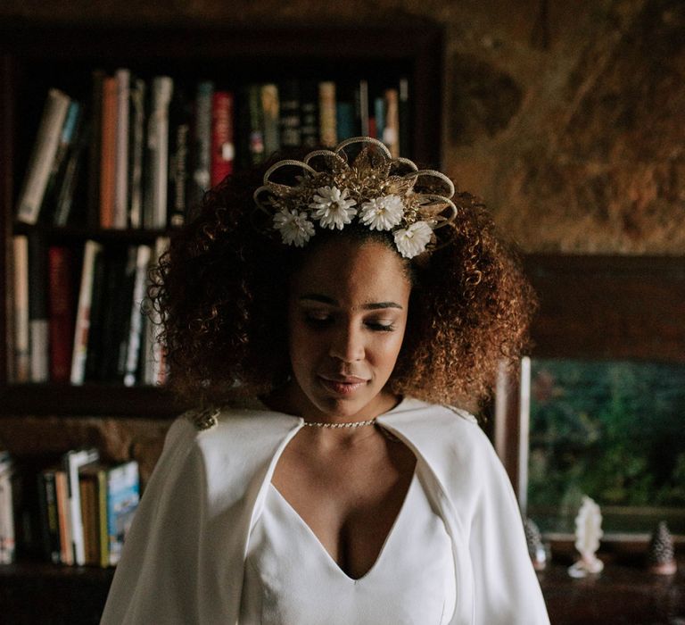 Beautiful black bride with curly hair in gold headdress and wedding cape