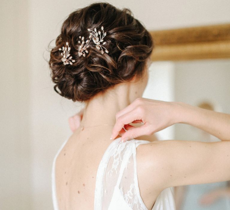 Pinned bridal updo with wedding hair accessories