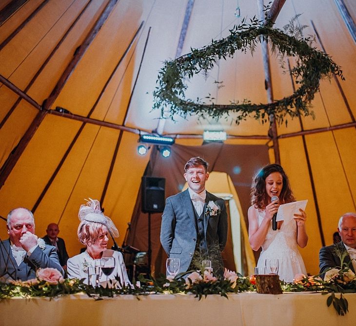 Rustic Hoop Decor Tipi Wedding Image by Claire Fleck Photography