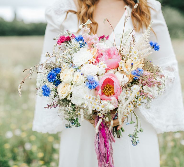 Colourful wildflower wedding bouquet with pink peonies