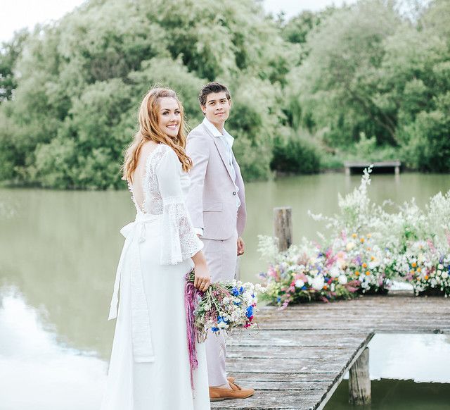 Bride and groom standing on a dock