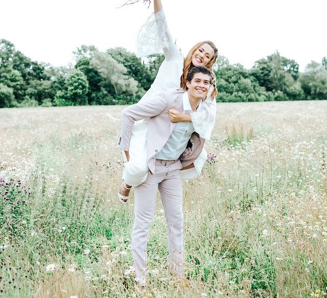 Groom carrying his bride on his back