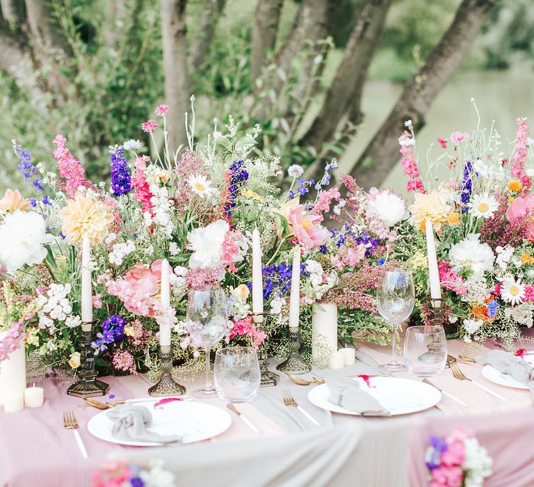 Table decoration with wildflowers and candles - wedding ideas for summer