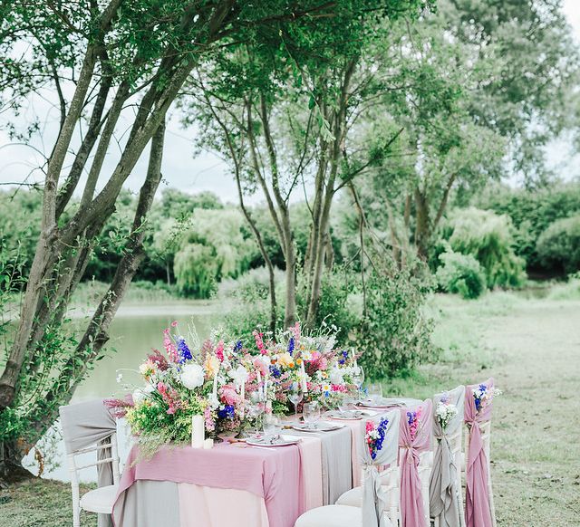 Outdoor reception table filled with wildflowers - wedding ideas for summer