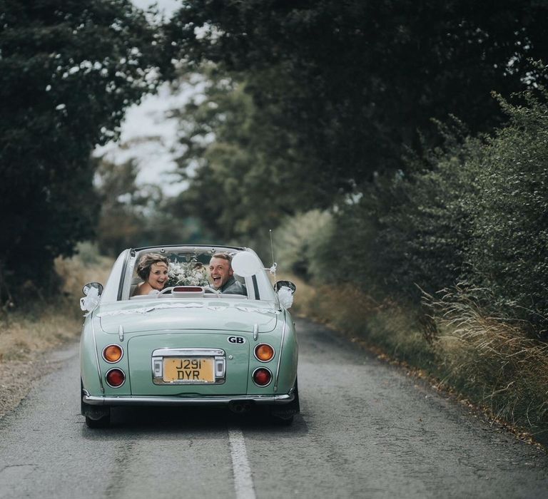 Bride and Groom Driving off into the Sunset