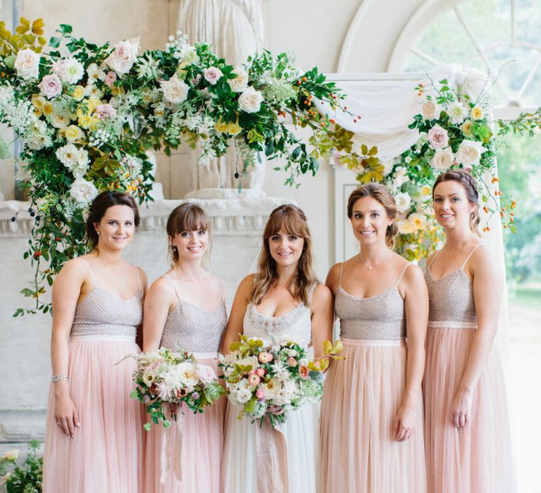 Bride and Bridesmaid Portrait with Floral Arch