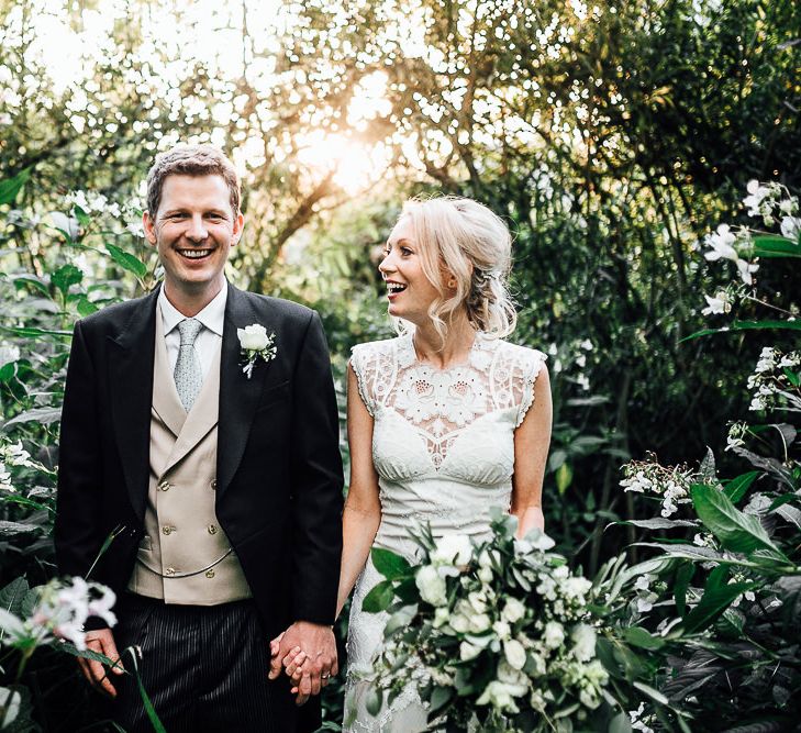 Bride and Groom Portrait with Sun Spray Through The Bushes