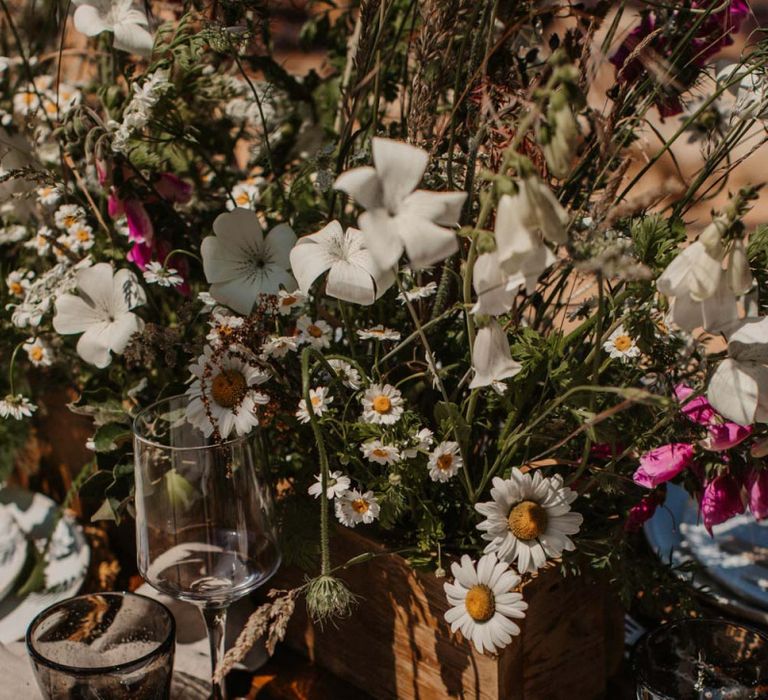 Place setting with wicker place mat and wildflower centrepieces