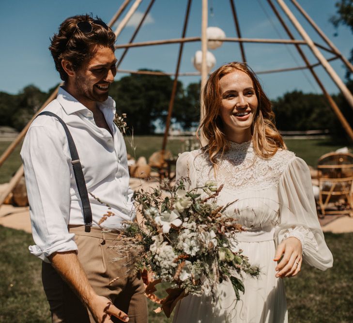 Boho bride and groom at eco-friendly wedding