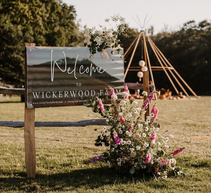 Wickerwood Farm wedding venue sign decorated with flowers