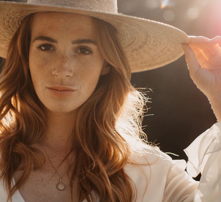 Boho bride wearing a straw hat