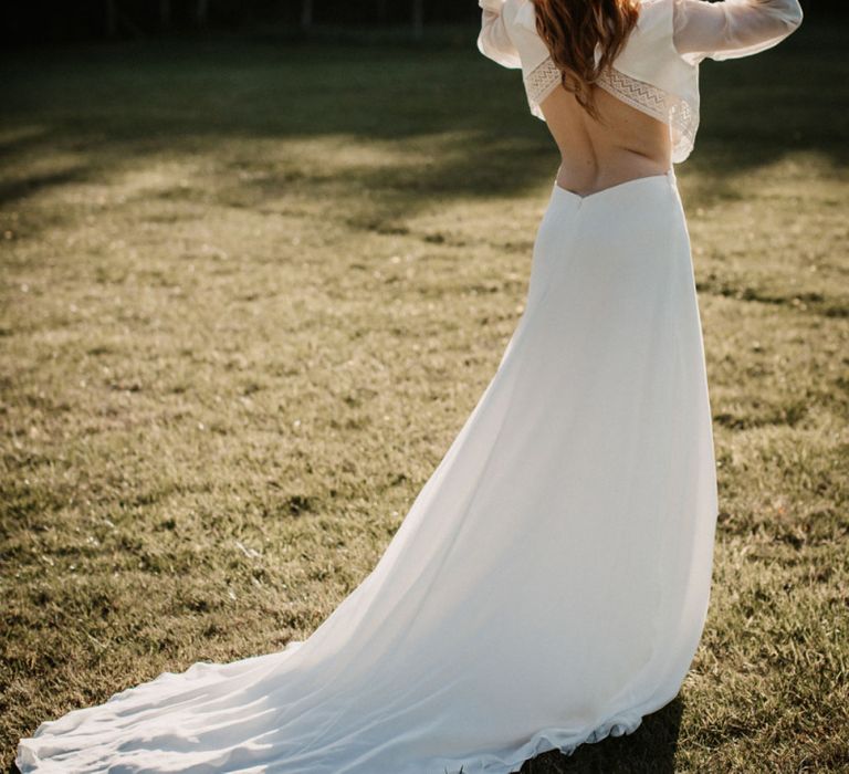 Boho bride in backless wedding dress and straw hat