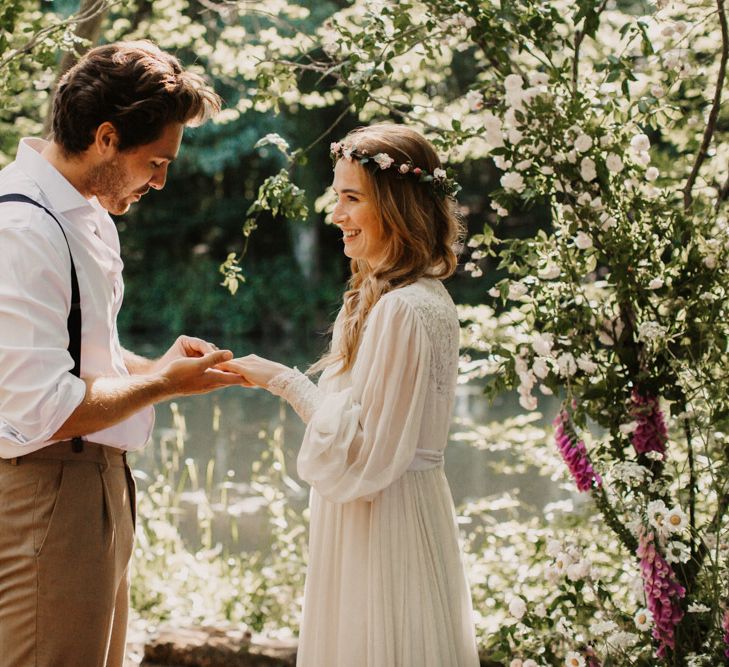 Bride and groom exchanging vows at woodland wedding ceremony