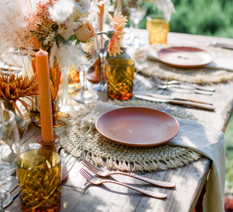 Ratan Place Setting with Gold Cutlery, Orange Candles and Dried Flowers