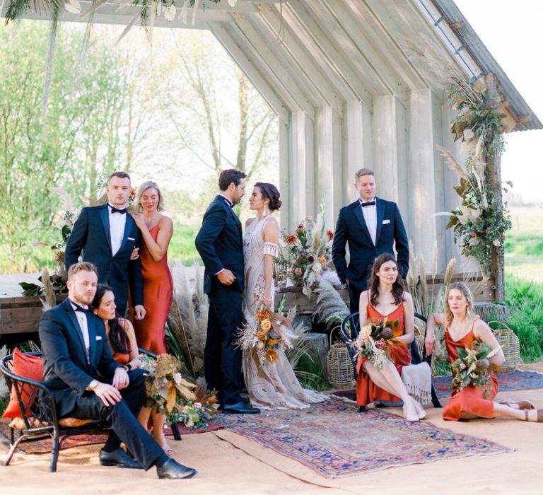 Wedding Party Portrait with the Dried Flower Decorated Ceremony Hut as the Backdrop