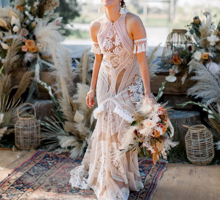 Laughing Bride in Rue de Seine Boho Wedding Dress with Orange Protea Bridal Bouquet