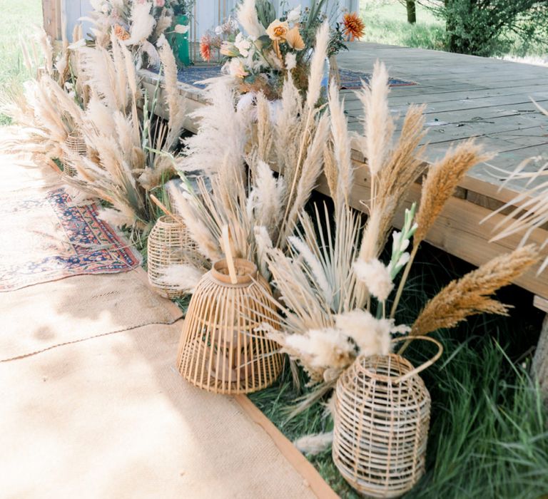 Pampas Grass Stems in Wicker Baskets Decorating the Outdoor Wedding