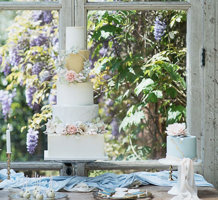 Dessert Table For Wedding With Iced Cake With Sugar Flowers // Winter Wedding Inspiration At Sennowe Park Norfolk With Cornflower Blue And Gold Details With Images From Salsabil Morrison Photography