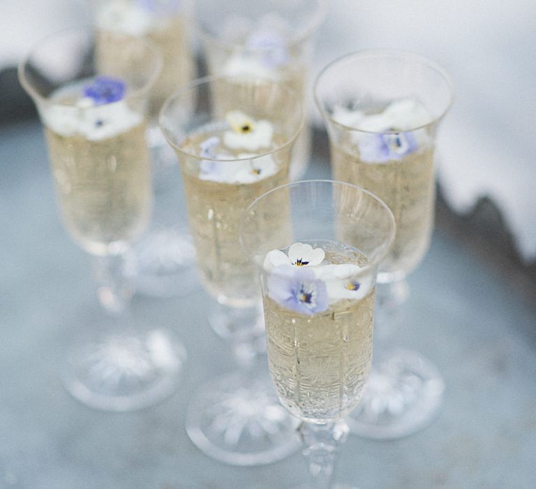 Champagne With Edible Flowers // Winter Wedding Inspiration At Sennowe Park Norfolk With Cornflower Blue And Gold Details With Images From Salsabil Morrison Photography