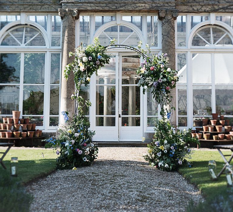 Floral Arch For Wedding Ceremony // Winter Wedding Inspiration At Sennowe Park Norfolk With Cornflower Blue And Gold Details With Images From Salsabil Morrison Photography