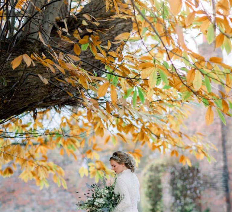 Bride in High Neck Wedding Dress Holding an Oversized Bouquet