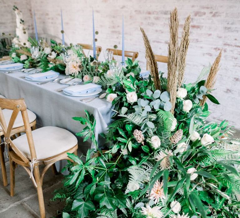 End of Table Floral Arrangement with Foliage, Dried Flowers and Roses.