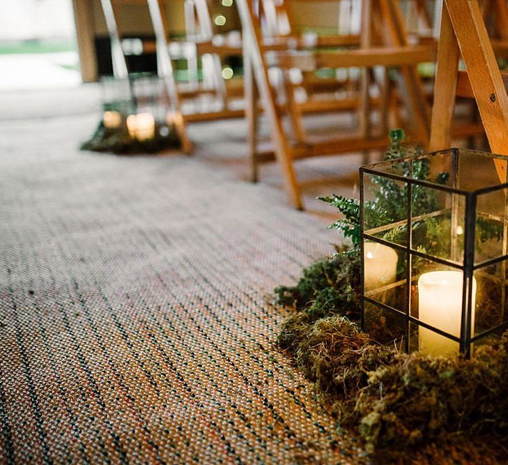 Candles in lanterns aisle decor