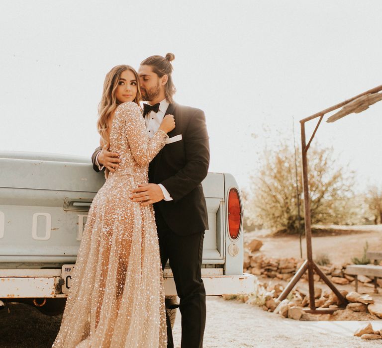 Bride in sparkly wedding dress and groom in tuxedo