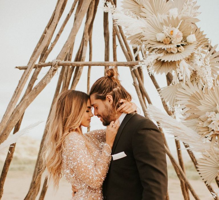 Intimate wedding portrait with bride in sparkly wedding dress