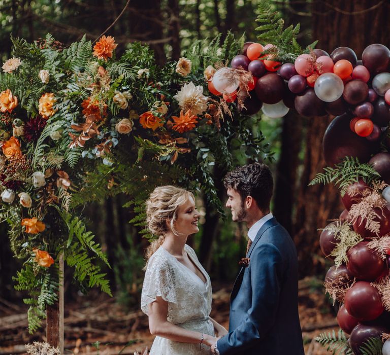 Autumnal Outdoor Wedding Reception In A Woodland // Balloon And Floral Arch For Wedding Ceremony At Patrick's Barn Woodland Industrial Wedding Venue With Grazing Board Style Food Images By Brigitte &amp; Thierry Photography