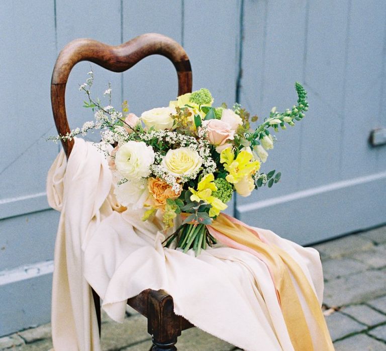 Yellow and White Wedding Bouquet Resting on a Chair