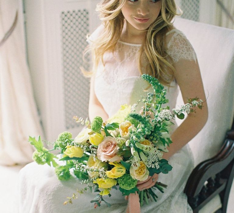 Bride in Naomi Neoh Wedding Dress with Yellow and Green Bouquet Tied with Ribbons