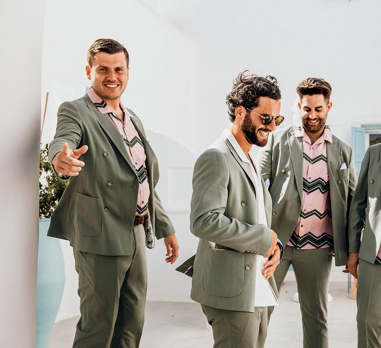 Sage green wedding suits with patterned shirts for groomsmen