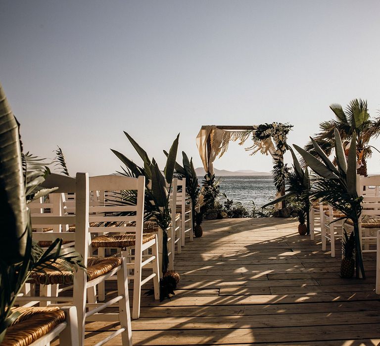 Beautiful Mykonos wedding ceremony with palm decor