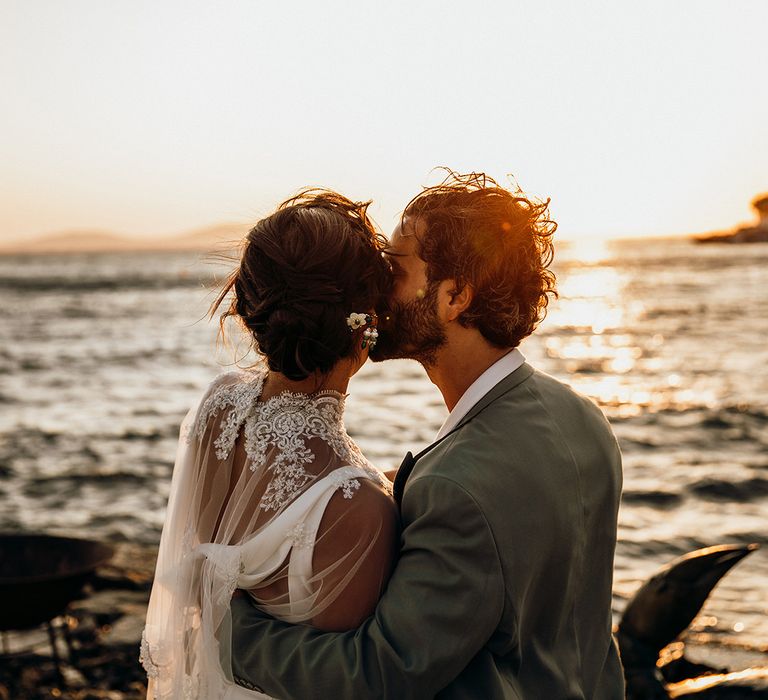 Wedding capelet for bride as she kisses groom