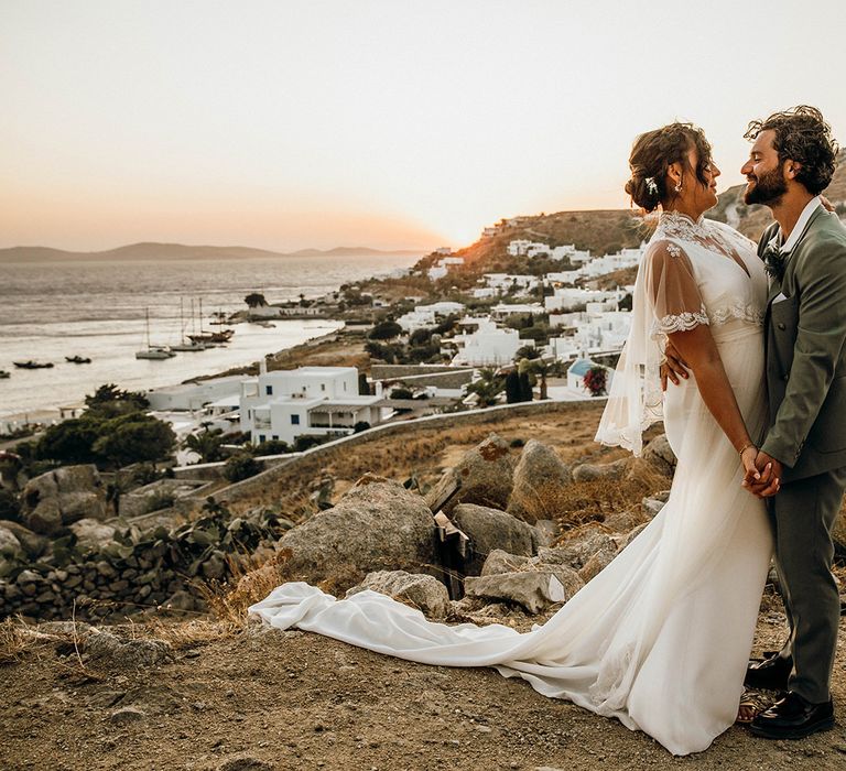 Bride in wedding capelet with groom at Mykonos wedding