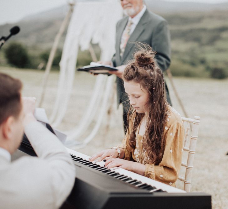 Young Bridesmaid Playing the Keyboard During the Wedding Ceremony