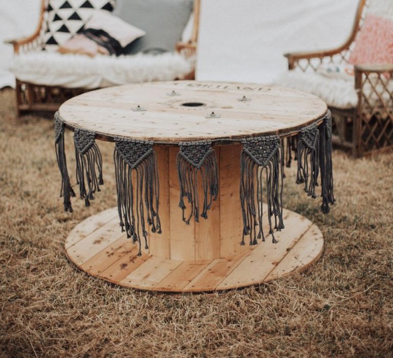 Large Cotton Reel as Table Decorated with Macrame Bunting