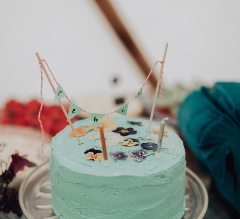 Single Tier Blue Buttercream Cake with Mini Bunting Decor