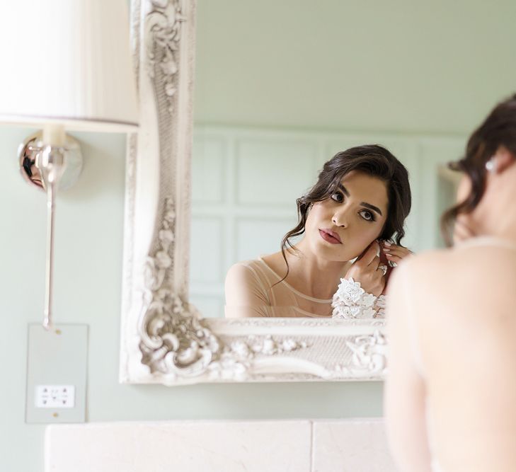 Bride Putting On Her Earrings During Wedding Morning Bridal Preparations