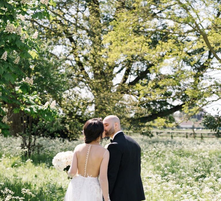 Bride and Groom Kissing in Elmore Court's Gardens