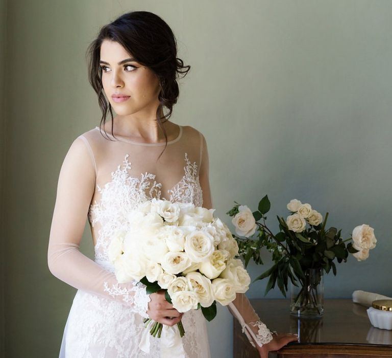 Beautiful Bride in Berta Wedding Dress Holding an All White Rose Wedding Bouquet