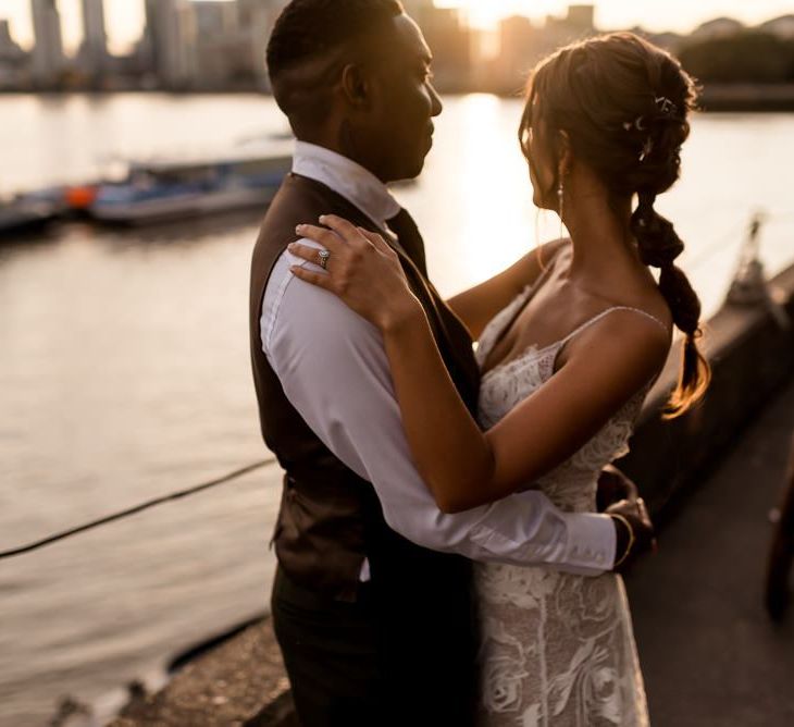 golden hour portrait of bride in Grace Loves Lace Rosa wedding dress and groom in waistcoat