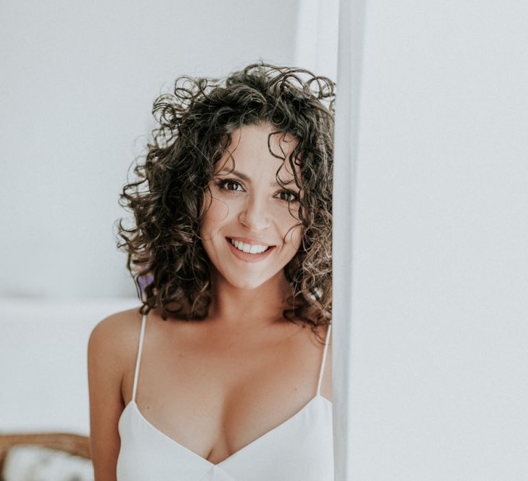 Curly haired bride in Max Mara wedding dress