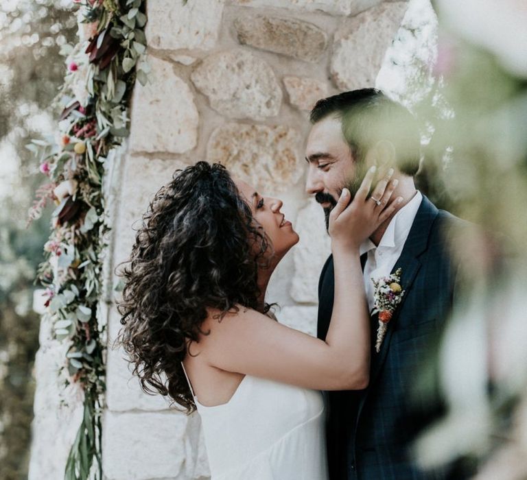 Bride in Max Mara dress kissing groom